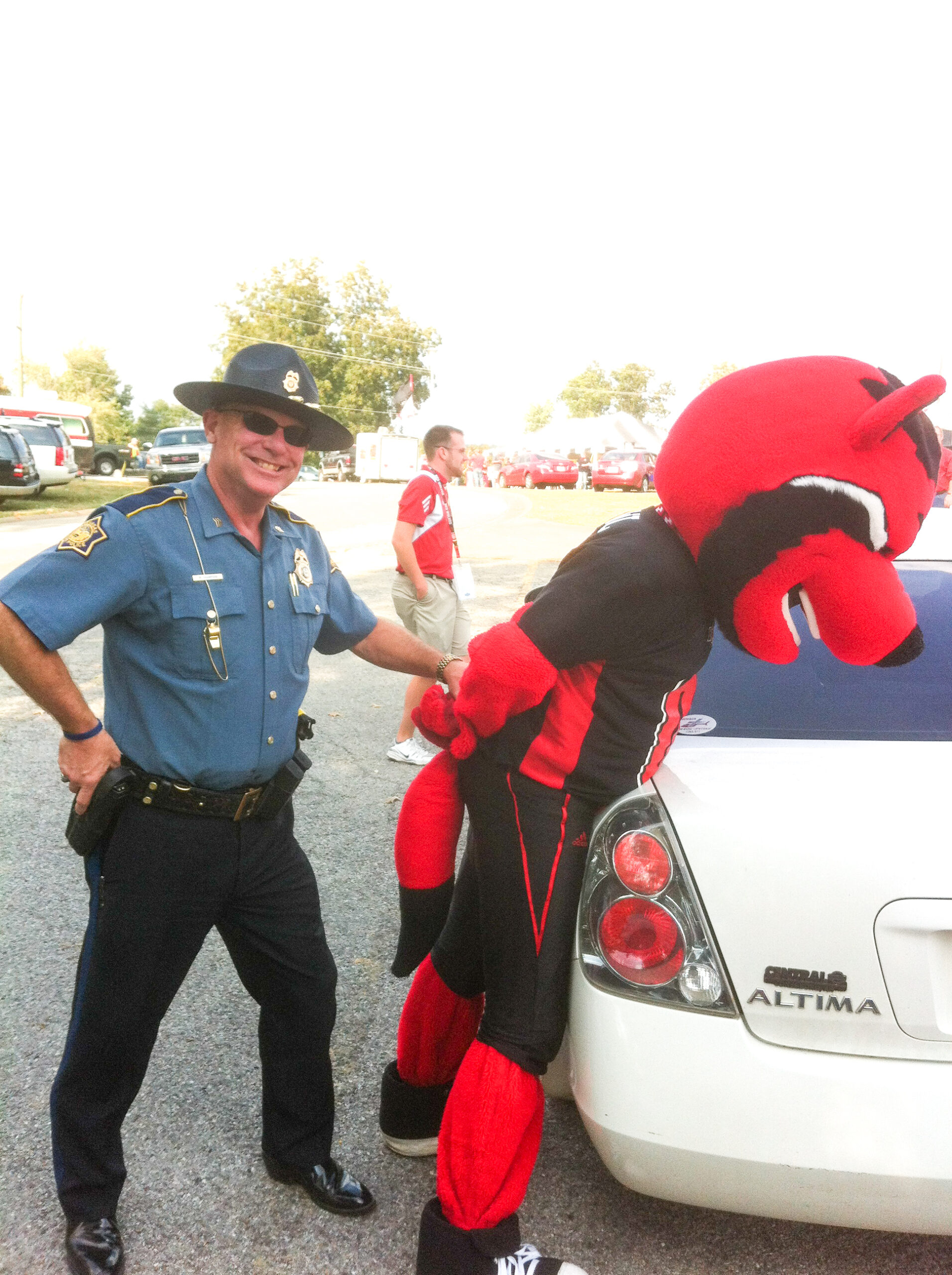 Mack enjoying a little fun with his beloved Arkansas State Red Wolves mascot, Howl, at a ASTATE football game prior to his retirement.